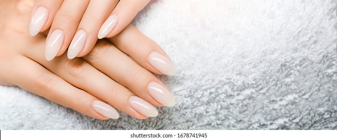 Manicure and Hands Spa. Beautiful Woman hand closeup. Manicured nails and Soft hands skin wide banner. Beauty treatment. Beautiful woman's nails with beautiful baby boomer manicure copy space for