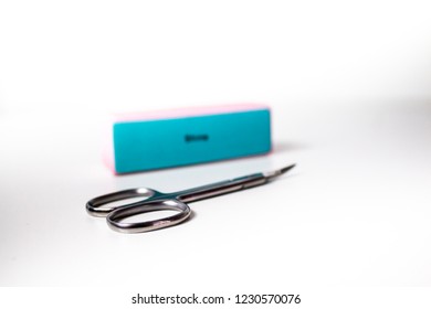 Manicure Nail Scissors And A Nail File / Buffer Isolated On White Background