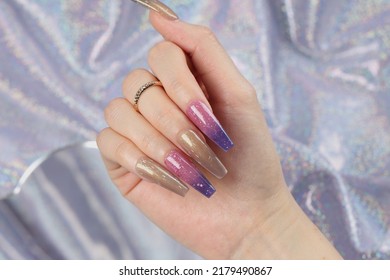 Manicure On Female Hand On Purple Background Nail Changing Color Polish