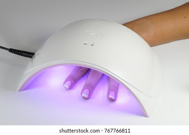 Manicure With Uv Led Lamp, Curing Gel Or Hybrid Varnish, Manicure On Table On Bright Background-horizontal