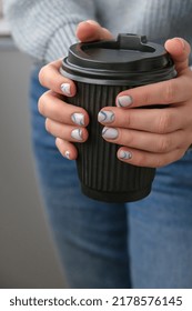 Manicured Female Hands Holding Black Eco Recycling Coffee Cup With Stylish Blue Nails And Minimalistic Design. Trendy Modern Design Manicure. Gel Nails. Skin Care. Wellness Beauty Treatment. Nail Care