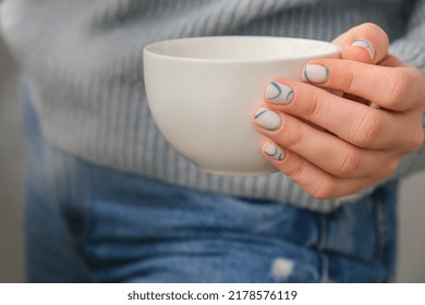 Manicured Female Hands Holding White Coffee Cup With Stylish Blue Nails And Minimalistic Design. Trendy Modern Design Manicure. Gel Nails. Skin Care. Wellness Beauty Treatment. Nail Care. Trendy Color