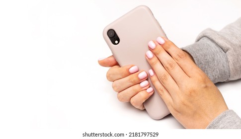 Manicured Female Hands With Stylish Light Pink Gel Nails Holding Mobile Phone. Trendy Modern Design Nails Manicure. Skin And Nail Care. Beauty Treatment And Wellness. Trendy Colors. Banner Copyspace