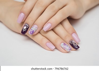 Manicured nails Nail Polish art design. Violet with green colors Art Manicure. Nail Polish. Beauty hands. Fashion Stylish Trendy Colorful Nails