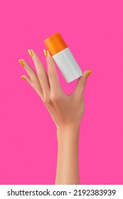 Manicured Womans Hand Holding Sunscreen Bottle On Pink Background