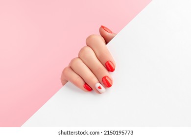 Manicured Womans Hand Holding White Paper. Fashionable Valentines Day Nail Design