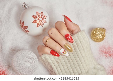 Manicured woman's hands. French manicure and candy cane pattern on the nails.