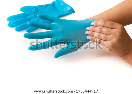 manicured woman's hands wearing sanitary gloves. Isolated with a white background.