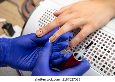 The Manicurist Applies A Topcoat To The Finished Hybrid Nails With A Brush.
