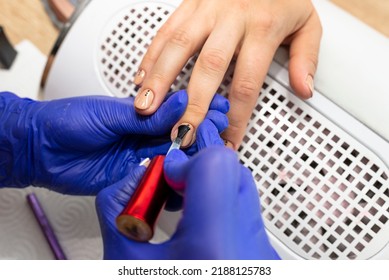 The Manicurist Applies A Topcoat To The Finished Hybrid Nails With A Brush.
