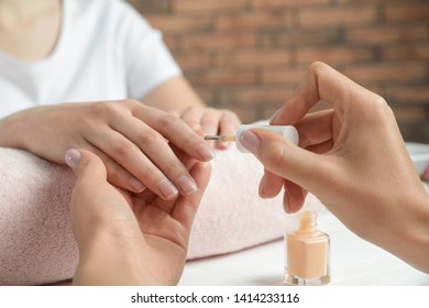 Manicurist Applying Polish On Client's Nails At Table, Closeup. Spa Treatment