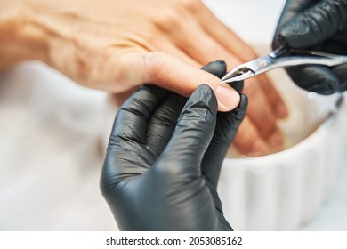 Manicurist Nipping Away Skin From Nail With Cuticle Cutter