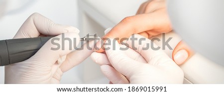 Similar – Woman filing nails in colored background