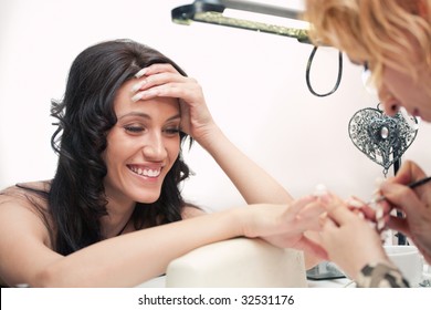 Manicurist Treating Client At Beauty Nails Salon. Manicure, Painting On Nail