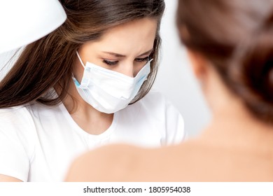 Manicurist Wearing Protective Mask Painting Female Nails With Nail Polish In Manicure Salon.