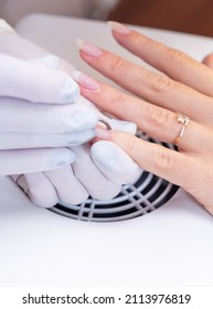 Manicurist With White Gloves Uses A Cuticle Tool. Beauty Treatments In Beauty Salon.