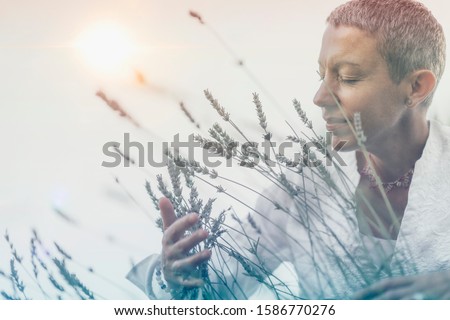 Manifesting Abundance. Mindful Woman Feeling Good, Enjoying the Scent of Lavender Flowers