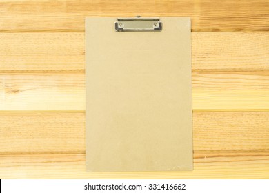 Manila File Folder On White. White Paper Hang On Wood Background, Stack Of Paper With Clip.on Wooden Background.