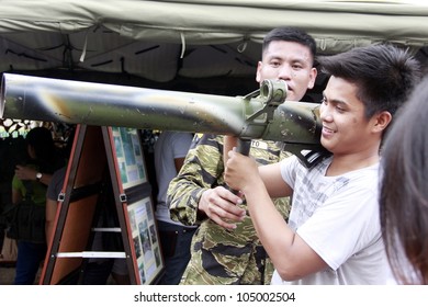 MANILA  JUNE 12:  Members Of The Armed Forces Show To A Student Their Firearms At The Philippines Independence Day On June 12, 2012  In Manila. The Philippines Celebrate The 114th Independence Day.