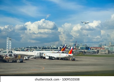 Manila NAIA Airport, Philippines - November 28, 2016: A Skyjet Plane Takes off, with a few Philippine Airlines planes unloading on the tarmac below.