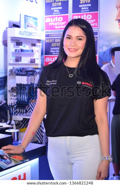 MANILA, PH - APR. 7: Bosch\
automotive aftermarket products female model at Manila\
International Auto Show on April 7, 2019 in World Trade Center,\
Manila, Philippines.