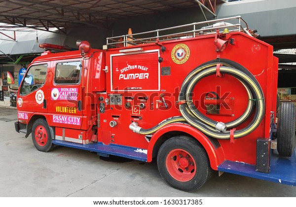 Manila, PH - JUNE 2, 2018: One old red fire truck\
stopping on the local street in Pasay City, Manila, Philippines,\
preparing for emergency\
case.
