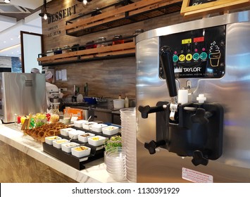 Manila, PH - JUNE 29, 2018: The Commercial Soft Serve Ice-cream Machine In A Restaurant, With Many Various Ice-cream Topping On The Table.