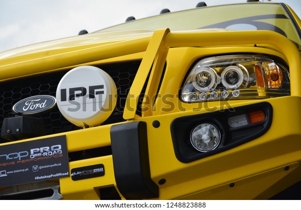 MANILA,\
PH - NOV. 30: Yellow Ford F150 pick up truck head light on November\
30, 2018 at Manila Auto Salon in Manila, Philippines. Manila Auto\
Salon is a aftermarket car show in\
Philippines.