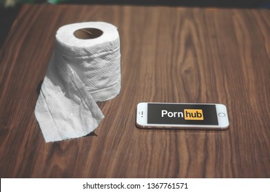 Manila - Philippines - April 2019 - Tissue paper roll placed beside a smartphone with Porn Hub logo. Ready to watch porn videos. Tissue paper ready for wiping off sperm after masturbating. 