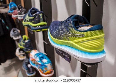 Manila, Philippines - Feb 2022: Asics Running Shoes For Display On A Wall Rack At A Local Boutique Store.