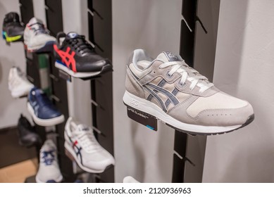 Manila, Philippines - Feb 2022: Asics Running Shoes For Display On A Wall Rack At A Local Boutique Store.