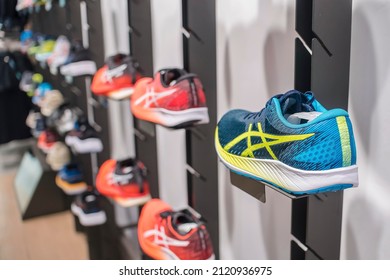 Manila, Philippines - Feb 2022: Asics Running Shoes For Display On A Wall Rack At A Local Boutique Store.