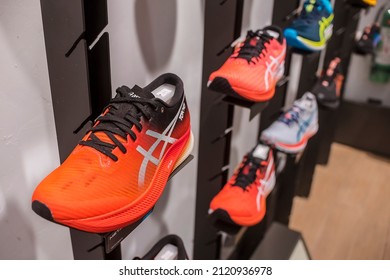 Manila, Philippines - Feb 2022: Asics Running Shoes For Display On A Wall Rack At A Local Boutique Store.