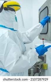 Manila, Philippines - Jan 2022: A Medical Technician Opens A Pass Box To Place A Test Sample At A Cleanroom At A Laboratory.