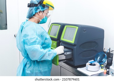 Manila, Philippines - Jan 2022: A Medical Technician In Full PPE Using PCR Machine, Also Known A Thermal Cycler, In A Cleanroom At A Testing Laboratory.