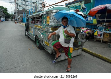Manila, Philippines - March 2022: A jeepney parked on a street in Manila on March 28, 2022 in Manila, Philippines. The jeepney is the urban transport of the city of Manila.