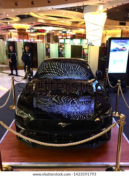 Manila, Philippines; May 25,\
2019: A shiny new black Mustang car on display outside a playing\
area at the City of Dreams Hotel, Resort and Casino in Paranaque\
City.