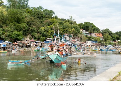 Manila, The Philippines - November 28 2021: A typical Filipino fishing village with moored traditional Banka fishing boats.   
