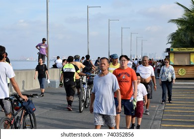 Manila, Philippines - October 22, 2017:  Asian People Doing Walking Exercise Along Ocean Bay Break Water