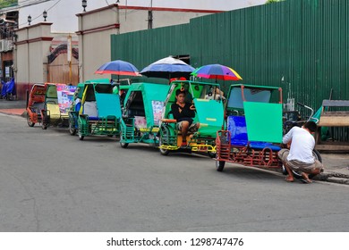 Manila, Philippines-October 24, 2016: Pedicabs are the easiest way of moving around when inside the Intramuros-Walled City area. Here stationed in a row at Sto.Tomas Street while waiting for customers