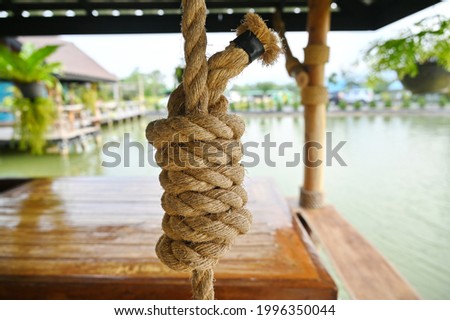 Manila or polypropylene rope is strongly braided into a spiral neatly wrapped with black masking tape. Used for hanging heavy objects or decorating a wooden pavilion in the water to be beautiful.