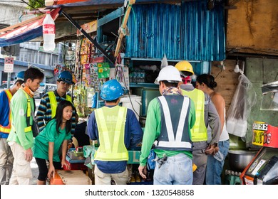 Manila/Philippines - February 2, 2019: Construction Workers Buying Food And Drinks At Sari Sari Store 