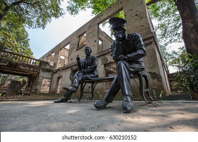 Manila,Philippines,25 March,2017: A Statue Of Soldiers Of The US Armed Forces Sit On The Bench In The Background Of A House Destroyed By The War