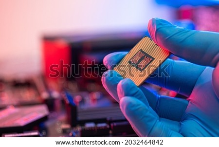 manipulating and installing processor on the motherboard in details with blur and selective focus