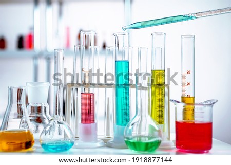 Manipulating pipette with liquid. Chemical laboratory