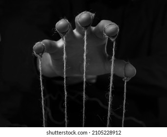 Manipulation concept. Hand of abuser manipulate with string.