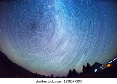 manipulation of luminosity when shooting allowed to clearly identify the direction of the stars in the night sky in the Alps mountains, Switzerland. Old house at the bottom of the shepherds tent - Powered by Shutterstock
