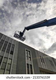 Manlift Crane With Platform Lifting To The Roof Top Of A Building