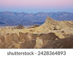 Manly beacon and the siltstone eroded foothills formations at zabriske point at sunrise, furnace creek, death valley national park, california, united states of america, north america