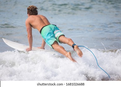 MANLY, NSW/AUSTRALIA – MARCH 2020: Young Adults Catching Waves Surfing At Manly Beach On A Bright Warm Sunny Day On Clear Blue Water